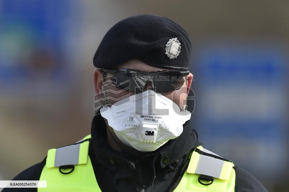 policeman, mask, control, traffic jam of trucks at the Bohumin - Chalupki crossing between Poland and the Czech Republic