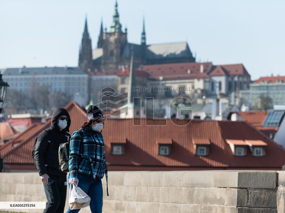 pair of pedestrians with protection face masks on the Charles Bridge in Prague, mask, pedestrian
