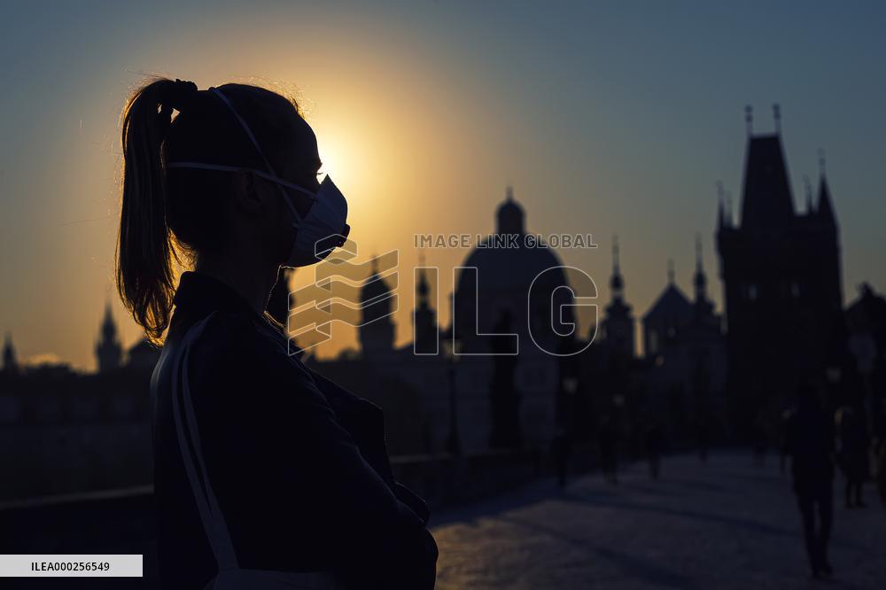 empty Charles Bridge in Prague, girl, face mask, coronavirus