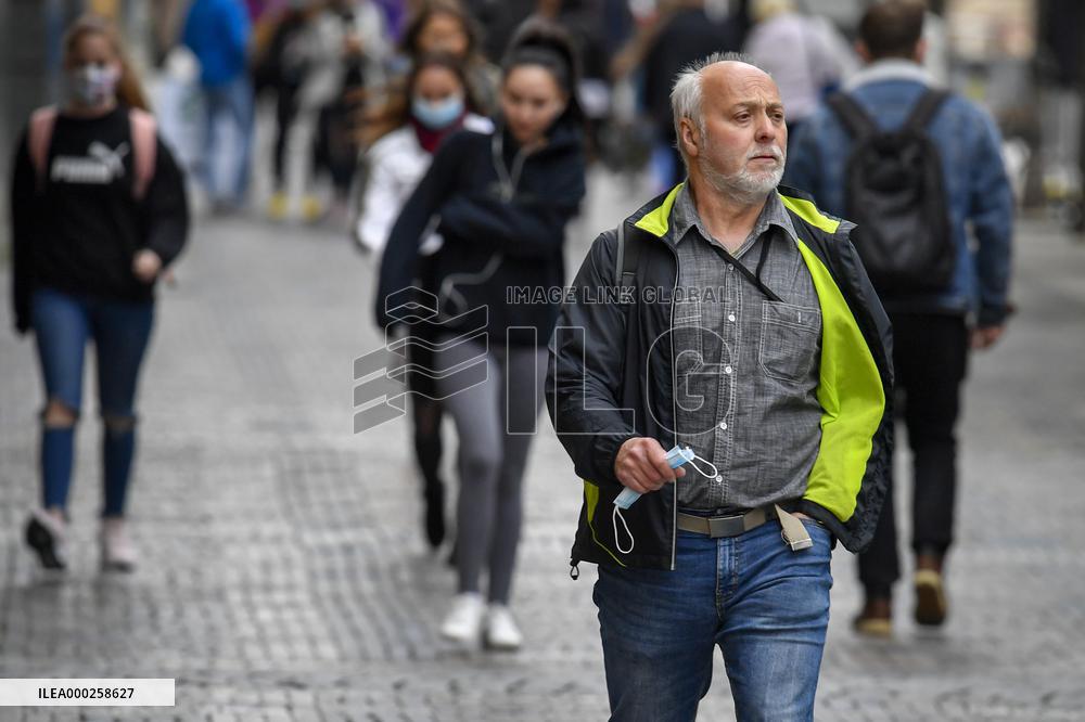 People without face masks walk on Wenceslas Square in Prague