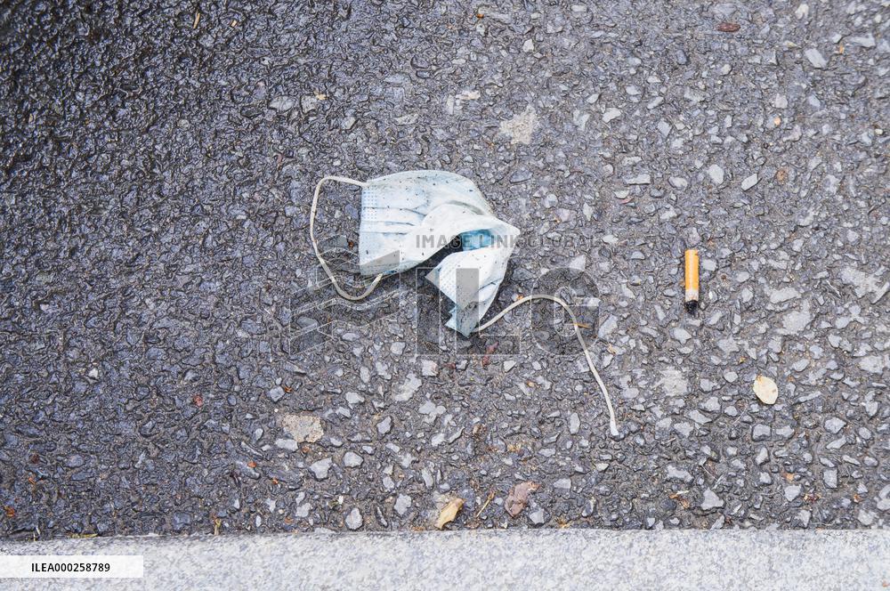 discarded face mask lies on the ground, pandemic, coronavirus, hazardous waste, fag end, cigarette stub