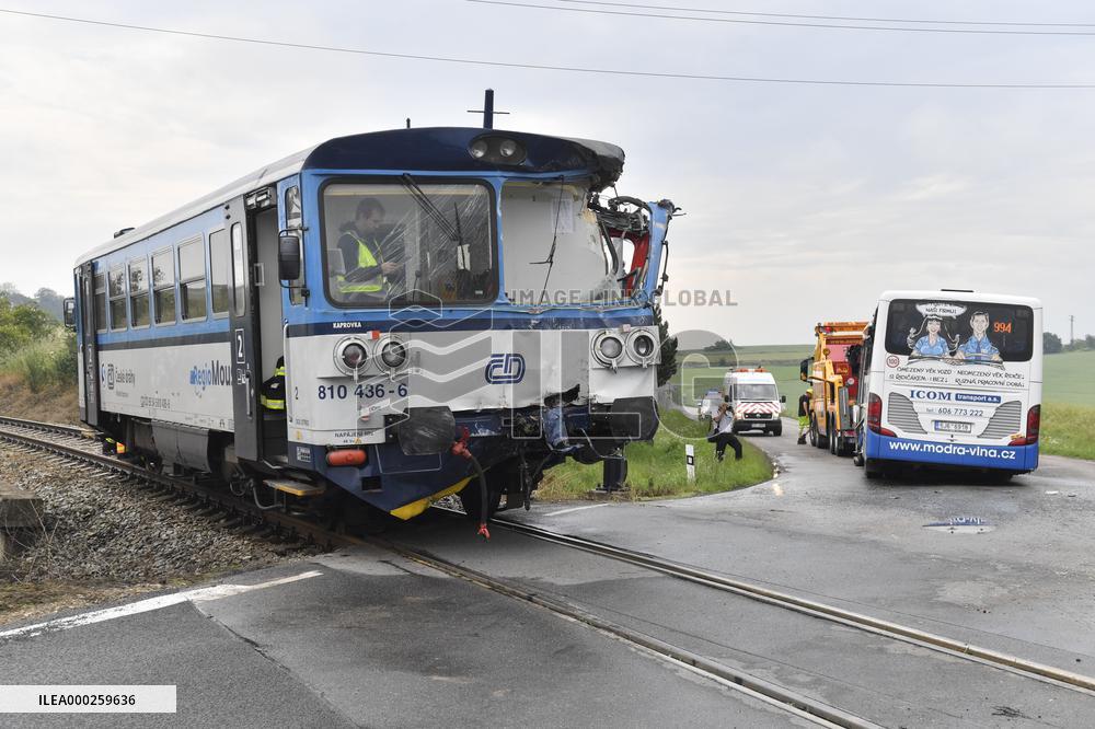 ten injured as train collides with bus at level crossing