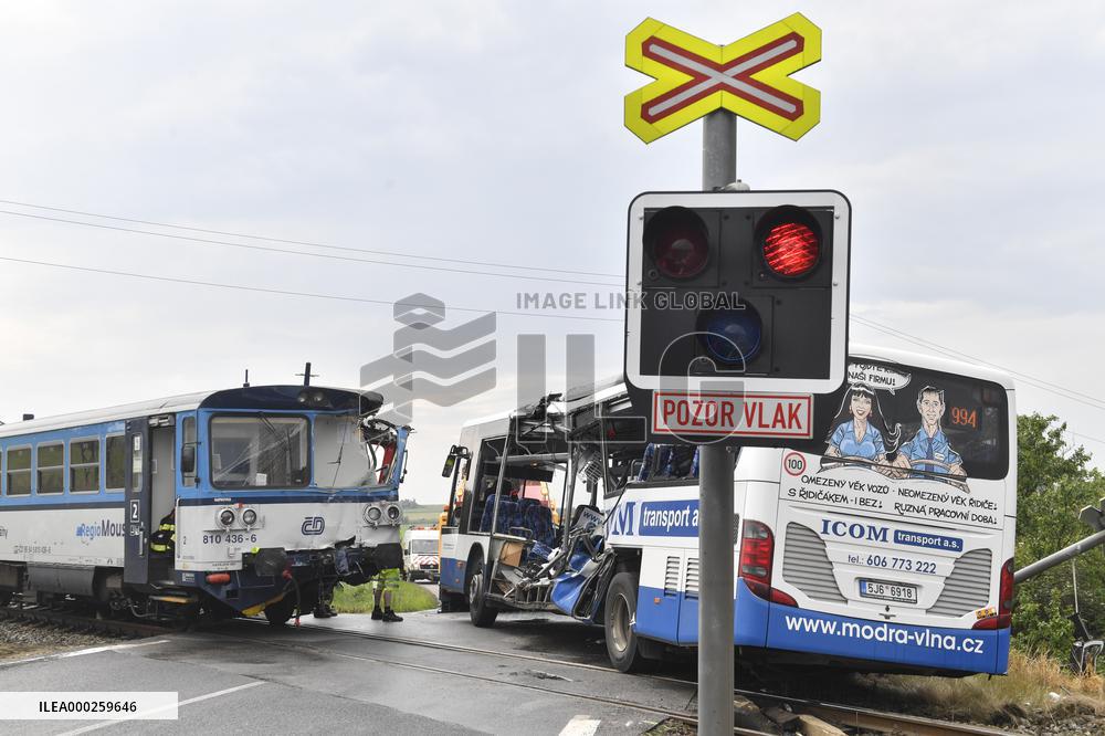 ten injured as train collides with bus at level crossing