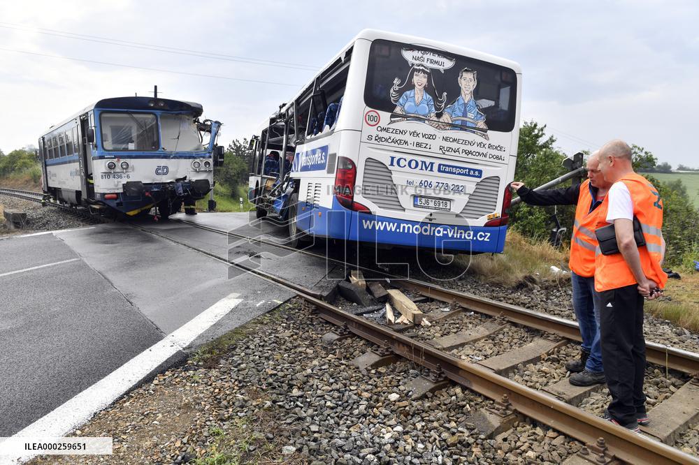 ten injured as train collides with bus at level crossing