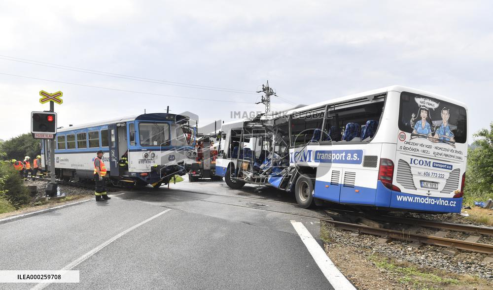 ten injured as train collides with bus at level crossing