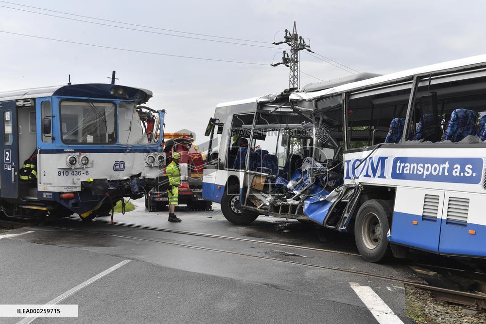 ten injured as train collides with bus at level crossing