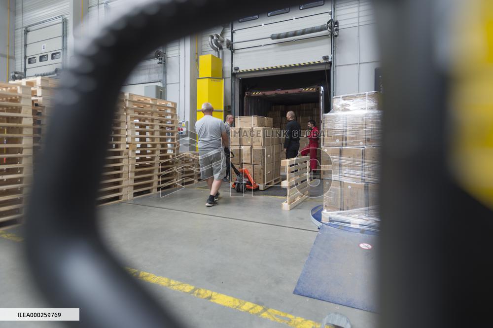 unloading boxes with medical protective equipment in storage facility in Opocinek
