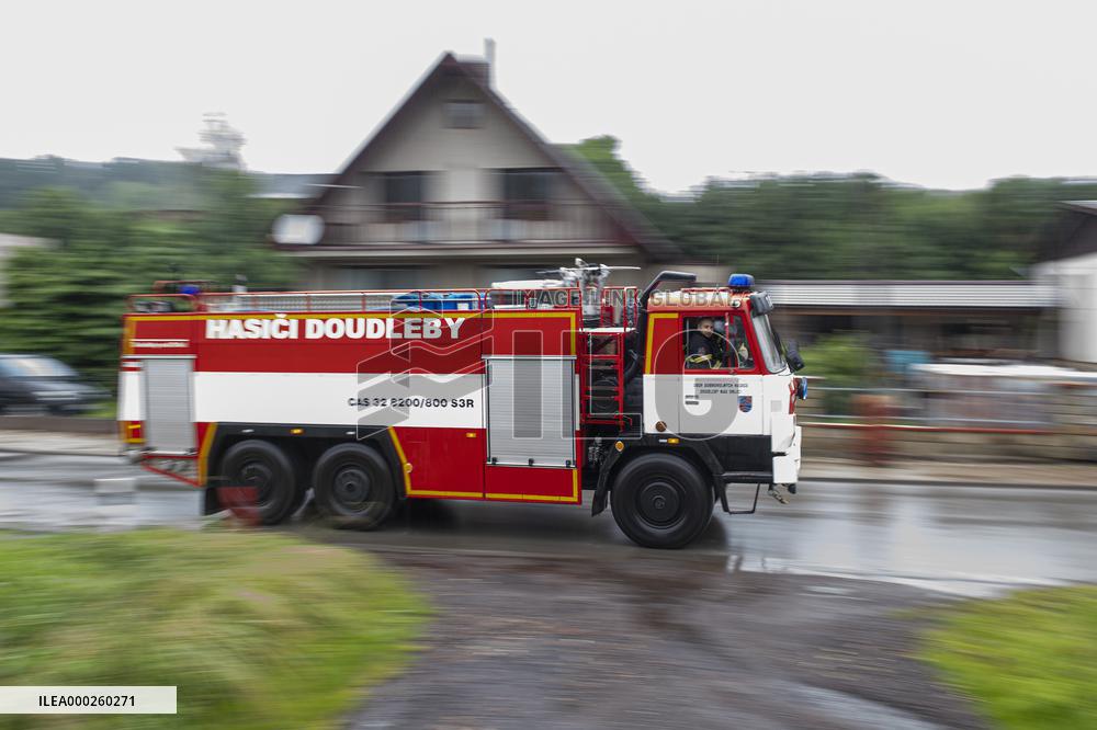 people removing damage of local flood, firefighters