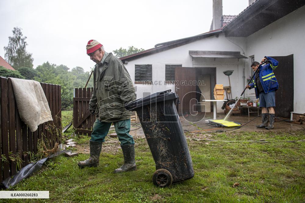 people removing damage of local flood