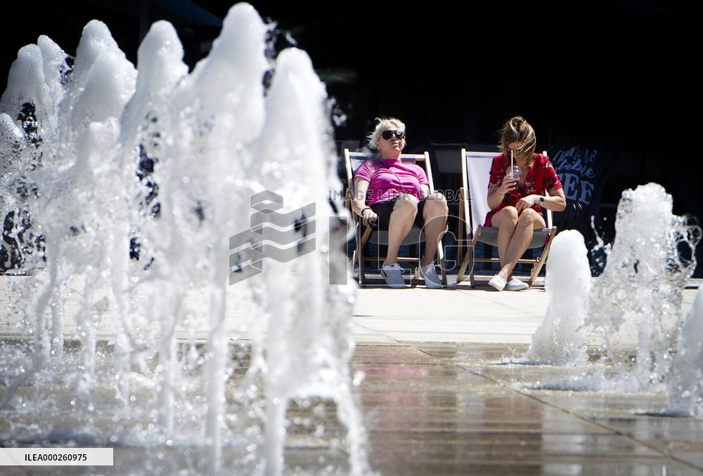 People relax in park, water, nice weather, without face mask