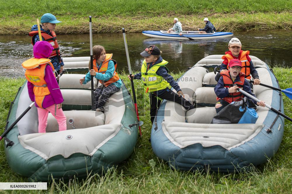 water tourists in a boat on the Orlice river, children