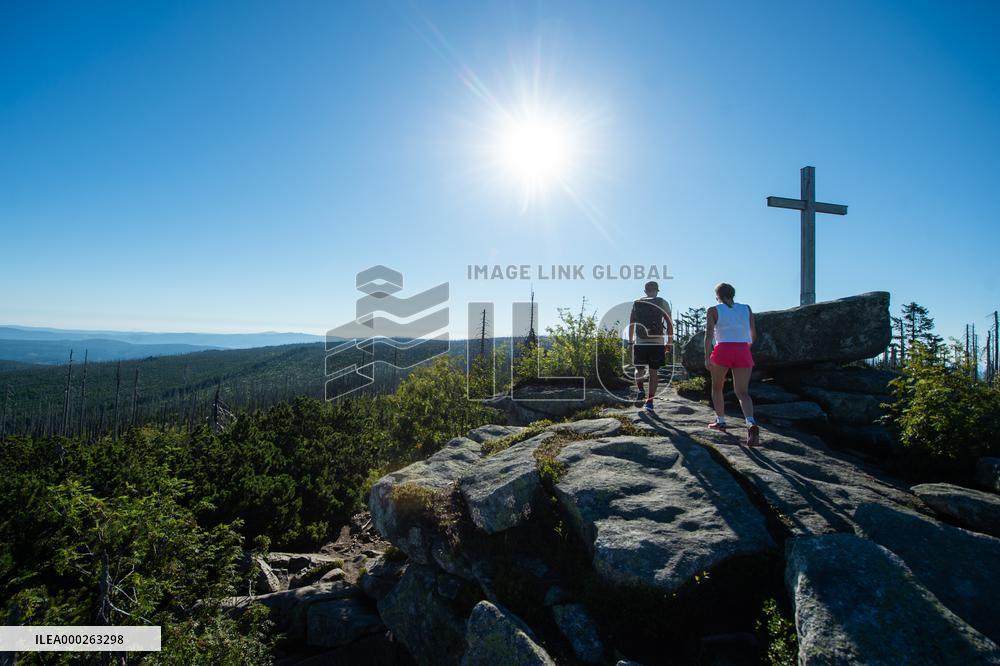 Bohemian Forest, Trojmezna Mountain (Three-border Mountain), tourists, sun, crucifix, rock