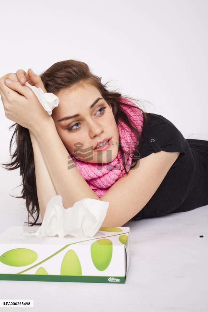 A beautiful young woman, lady, girl, cold, runny nose, headache, tissues, paper hankies, scarf, handkerchiefs, handkerchief, nose-blowing