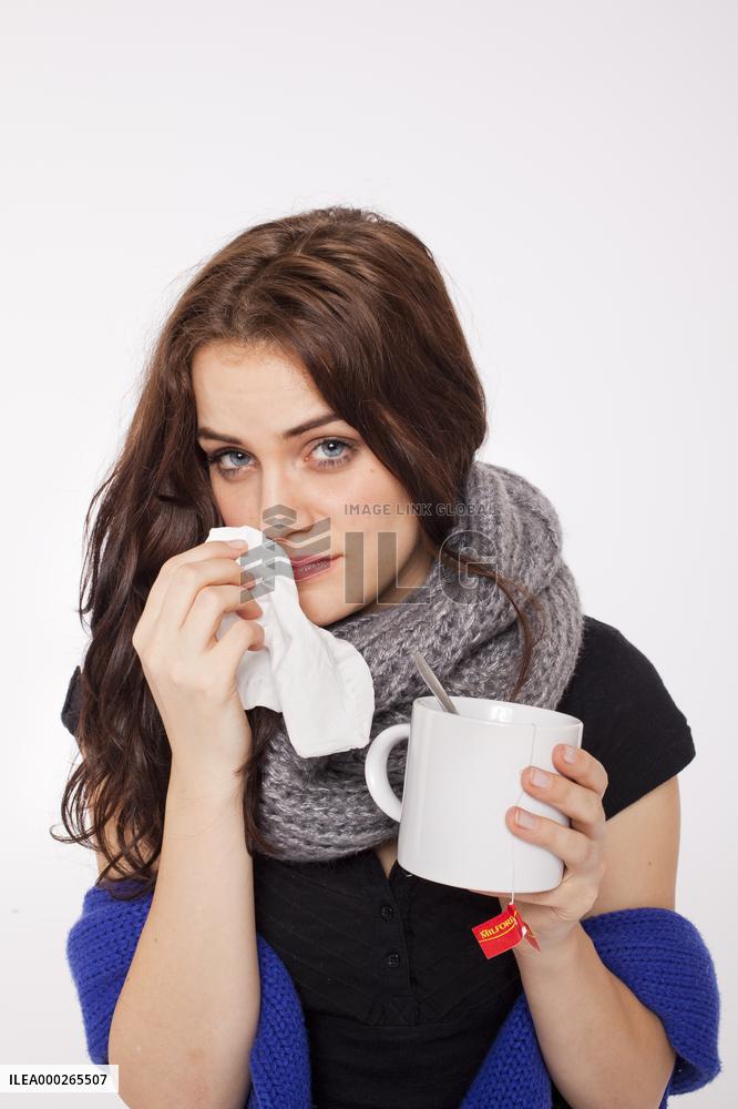 A beautiful young woman, lady, girl, cold, runny nose, headache, tissues, paper hankies, cup of tea, scarf, handkerchiefs, handkerchief, nose-blowing
