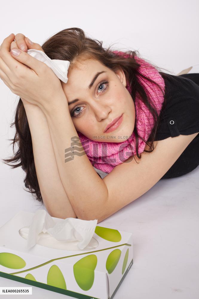 A beautiful young woman, lady, girl, cold, runny nose, headache, tissues, paper hankies, scarf, handkerchiefs, handkerchief, nose-blowing