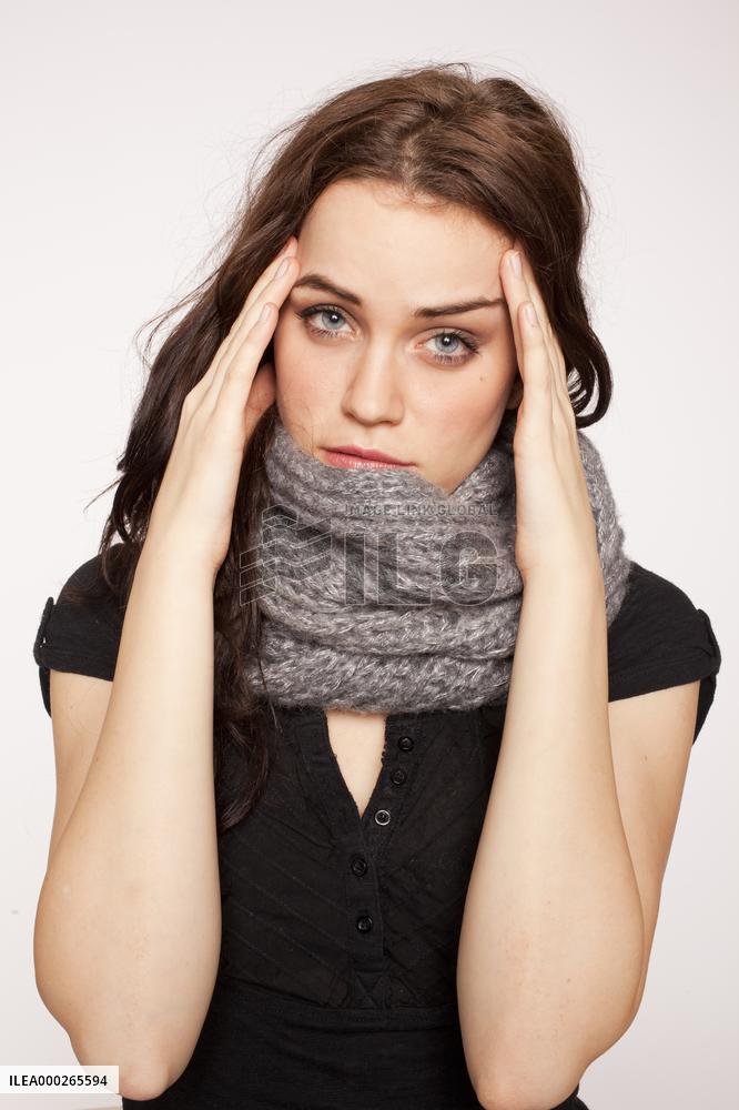 A beautiful young woman, lady, girl, cold, runny nose, headache, scarf