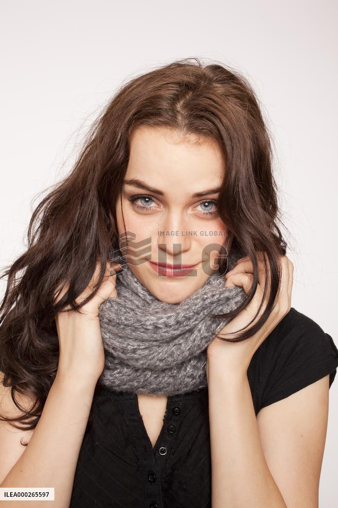 A beautiful young woman, lady, girl, cold, runny nose, headache, scarf