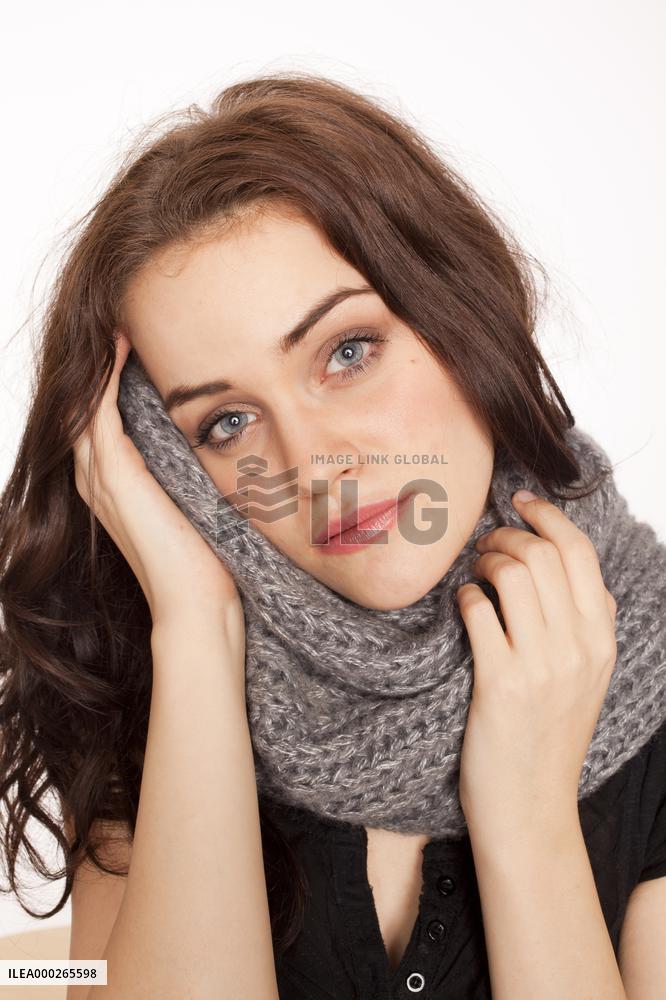 A beautiful young woman, lady, girl, cold, runny nose, headache, scarf