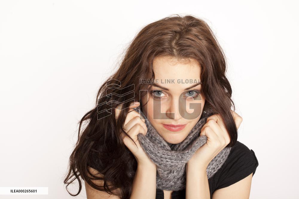 A beautiful young woman, lady, girl, cold, runny nose, headache, scarf