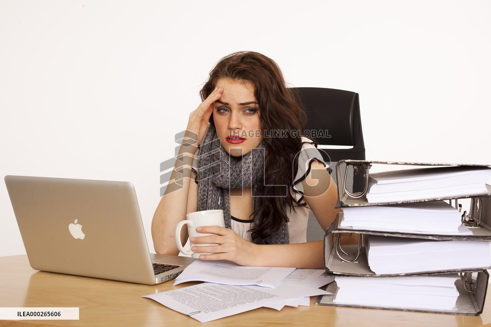 A beautiful young woman, lady, girl, secretary, personal assistant, office work, job, employee, worker, computer, notebook, MacBook Pro, paper work, folders