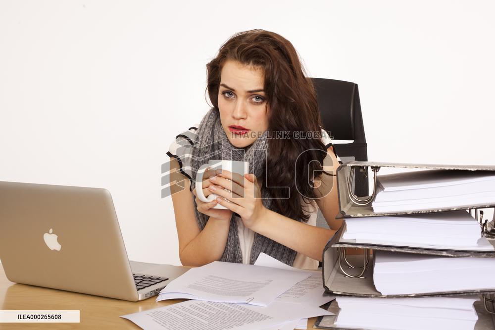A beautiful young woman, lady, girl, secretary, personal assistant, office work, job, employee, worker, computer, notebook, MacBook Pro, paper work, folders