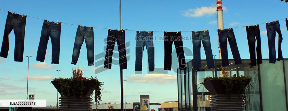 Jeans (blue)  hanging on a rope, clothes pins pegs