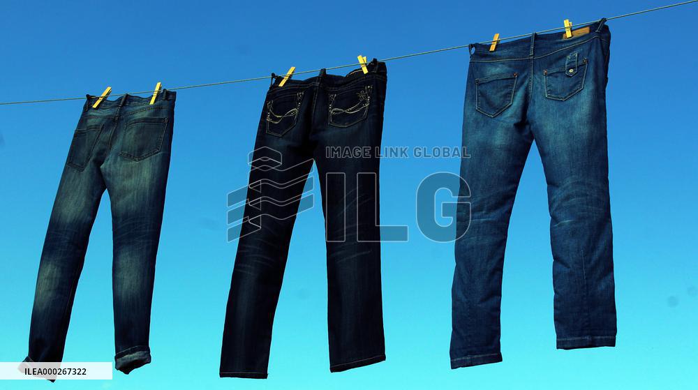 Jeans (blue)  hanging on a rope, clothes pins pegs