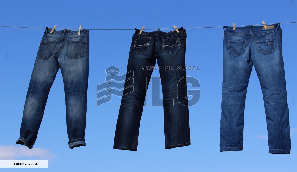 Jeans (blue)  hanging on a rope, clothes pins pegs