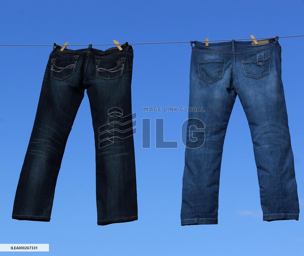 Jeans (blue)  hanging on a rope, clothes pins pegs