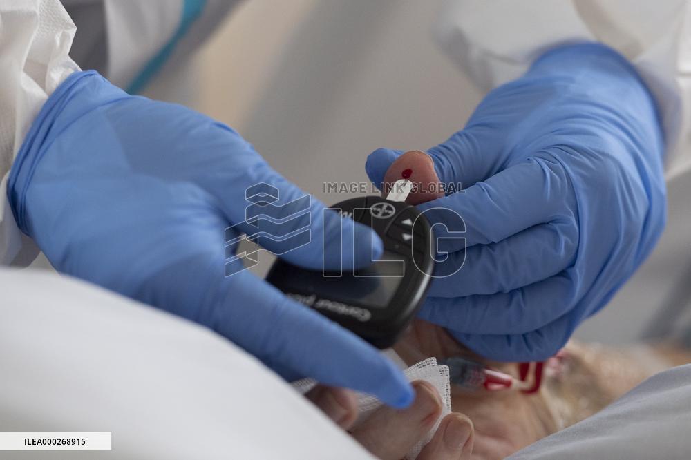 A medic nurses a patient at Intensive Care Unit