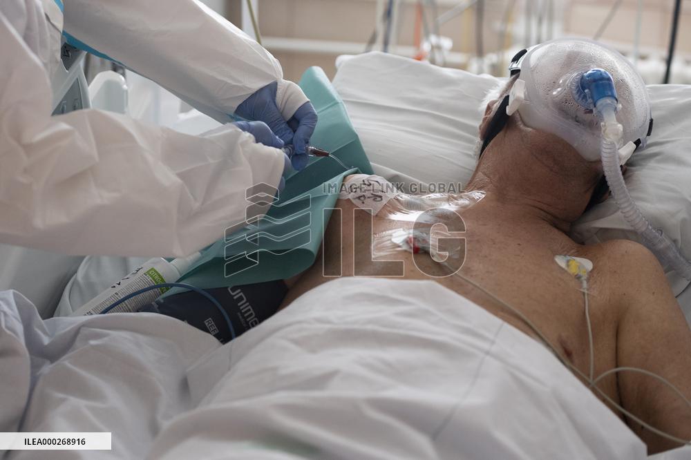 A medic nurses a patient at Intensive Care Unit