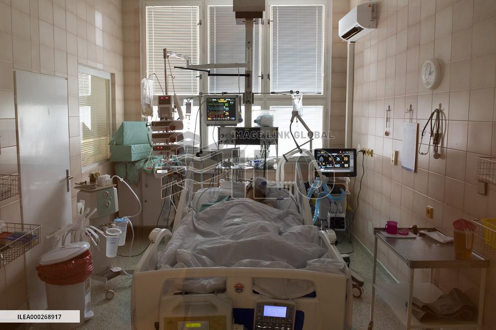 A medic nurses a patient at Intensive Care Unit