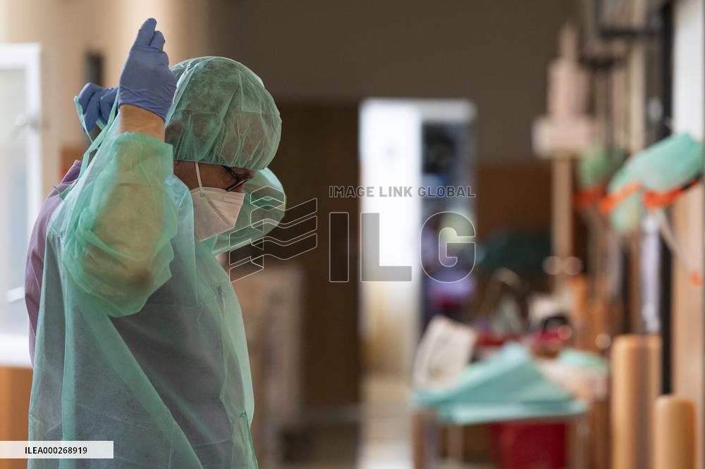 A medic nurses a patient at Intensive Care Unit