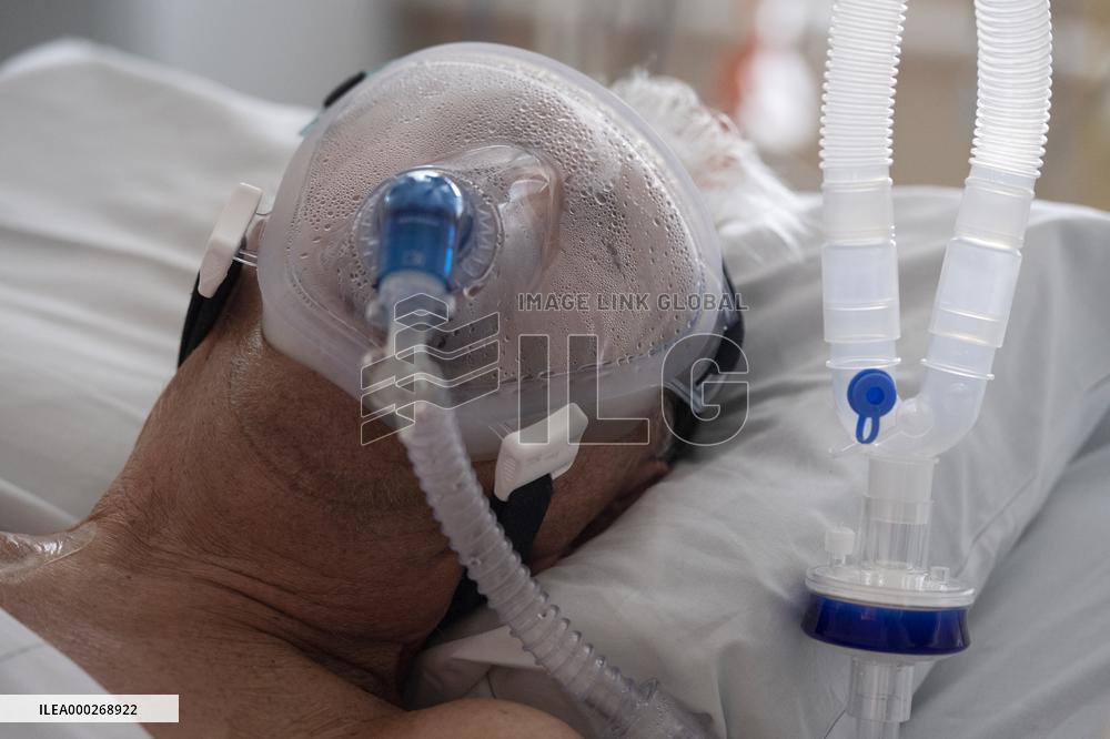 A medic nurses a patient at Intensive Care Unit
