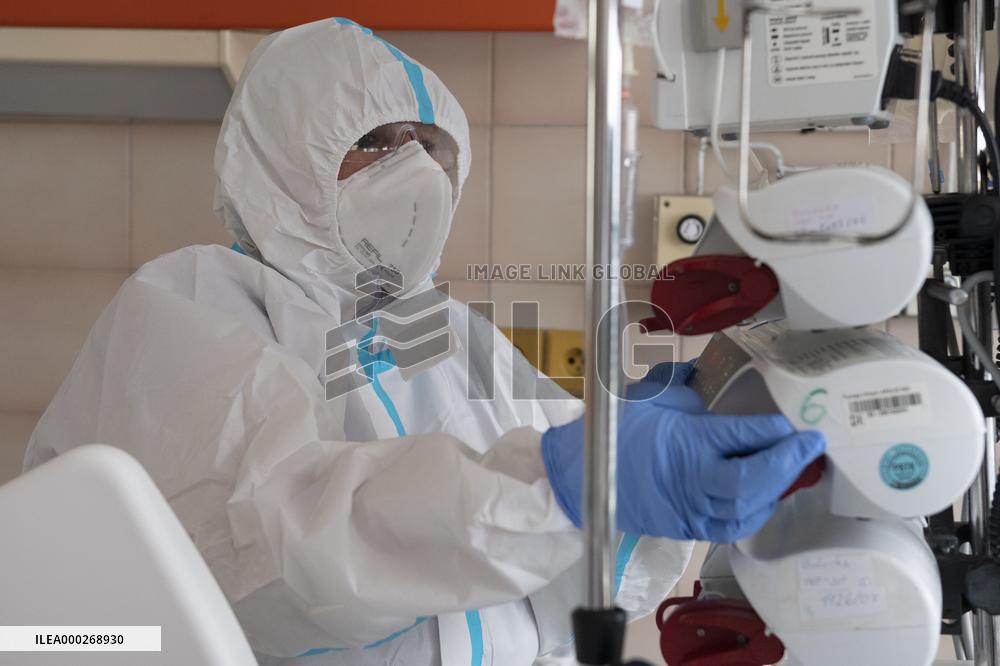 A medic nurses a patient at Intensive Care Unit
