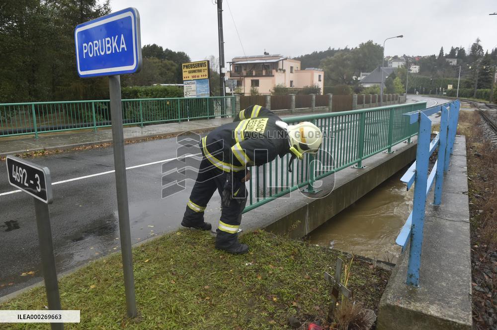 River Porubka, village Vresina, heavy rain, raised water level, fireman