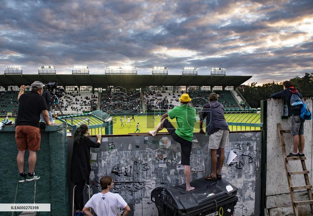 Bohemians fans on ladders behind the fence