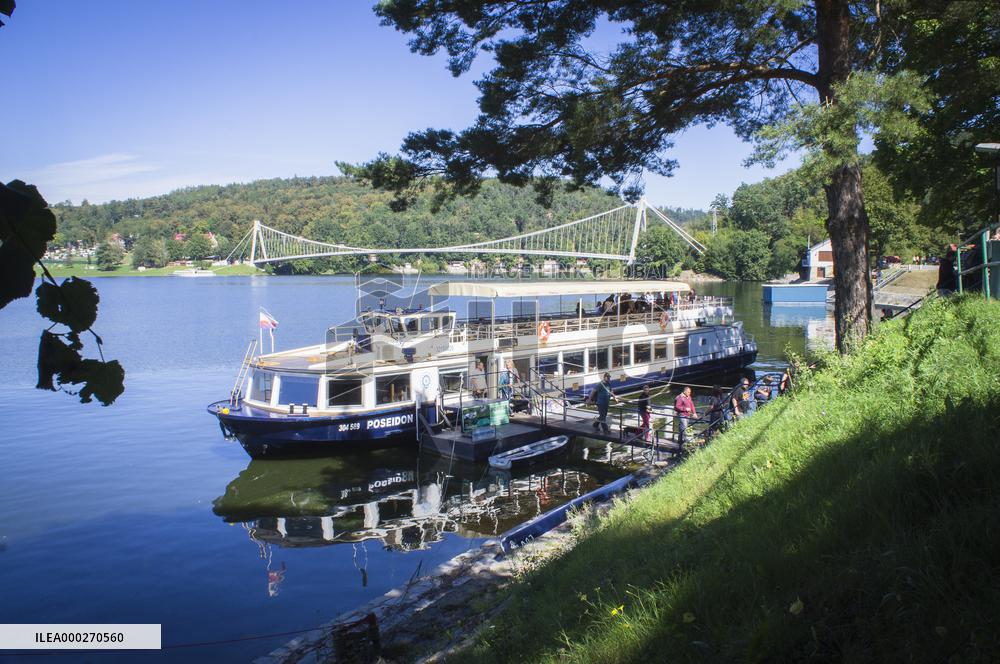 landing place with a pleasure boat at Vranov Dam, suspension footbridge over the Swiss Bay