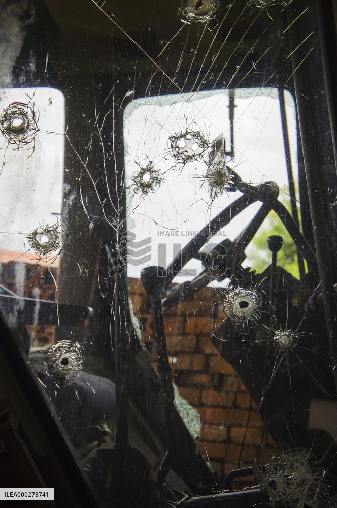 bullet hole shot through glass, tractor window