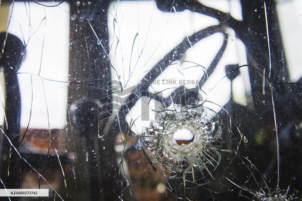 bullet hole shot through glass, tractor window