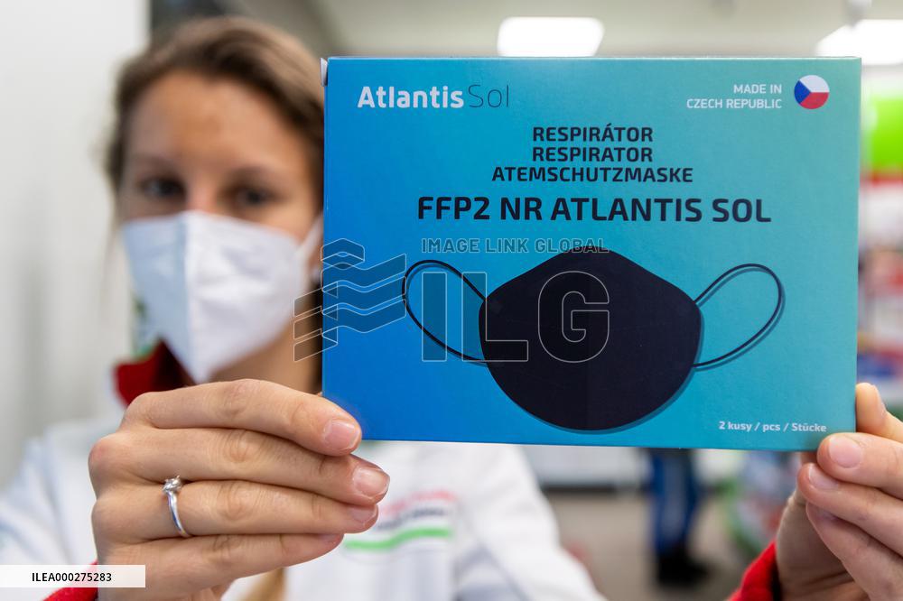 pharmacist shows packaged respirators of FFP2 category, pharmacy