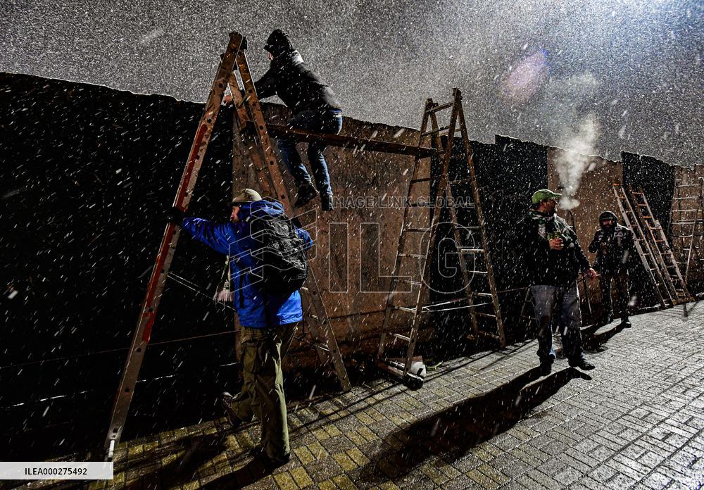 Bohemians fans on ladders behind the fence