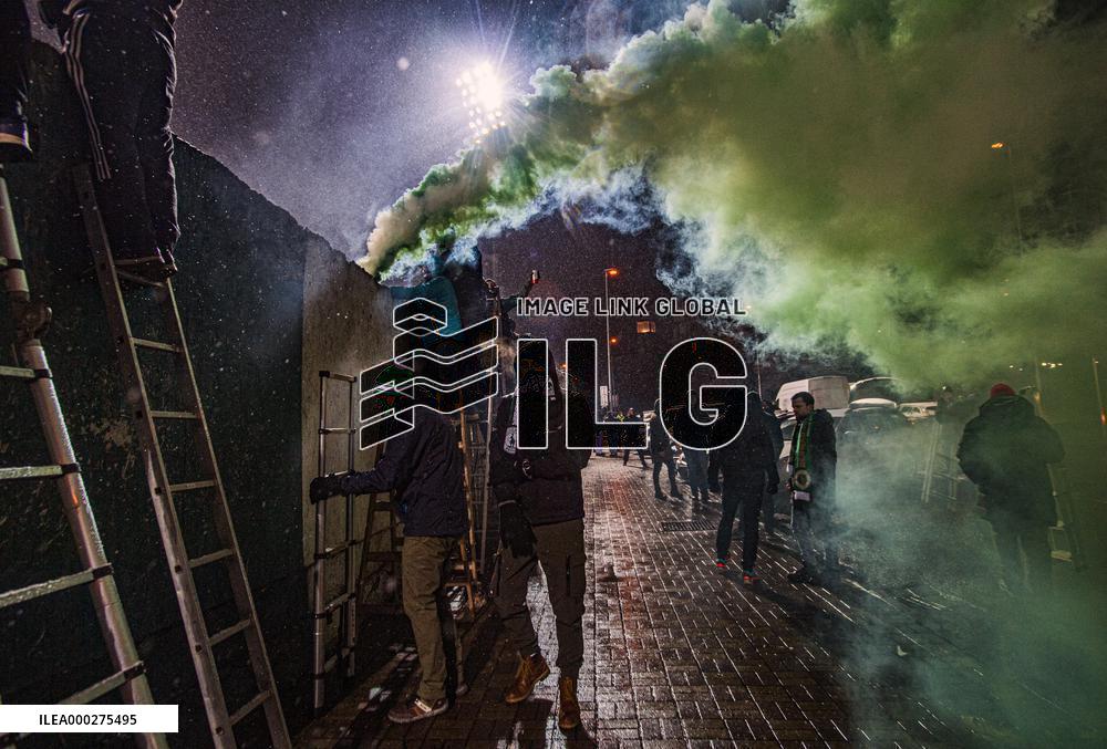 Bohemians fans on ladders behind the fence