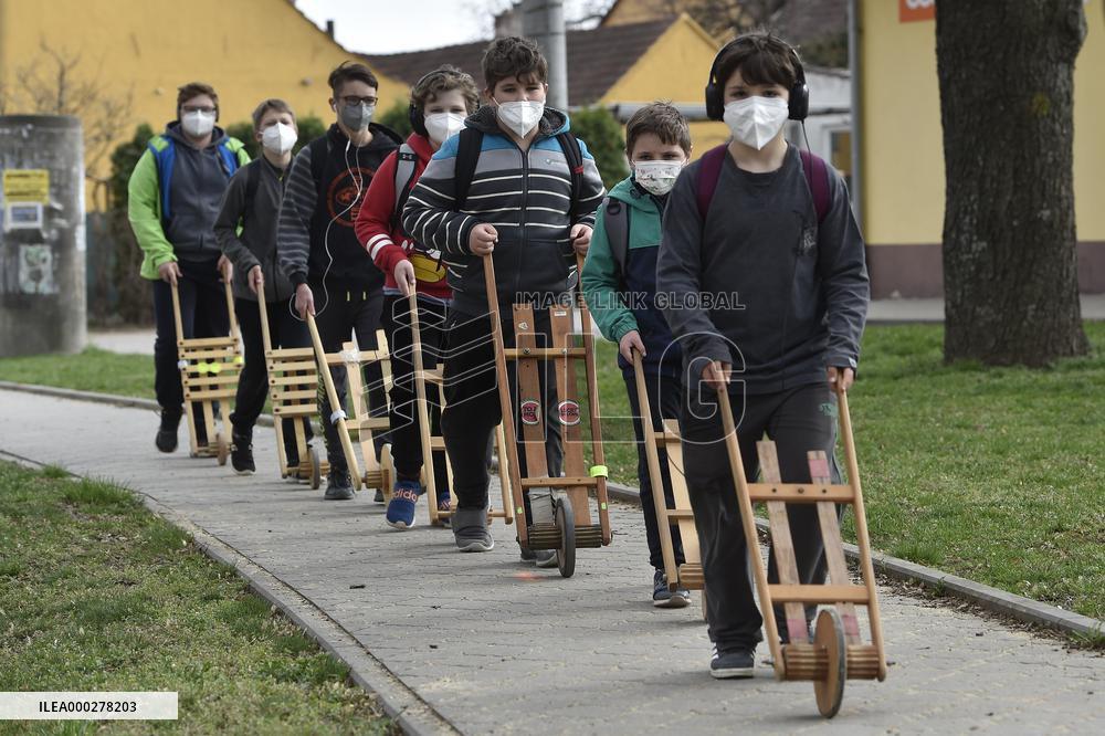 Children in moravian traditional dress with rattles