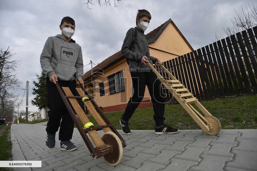 Children in moravian traditional dress with rattles