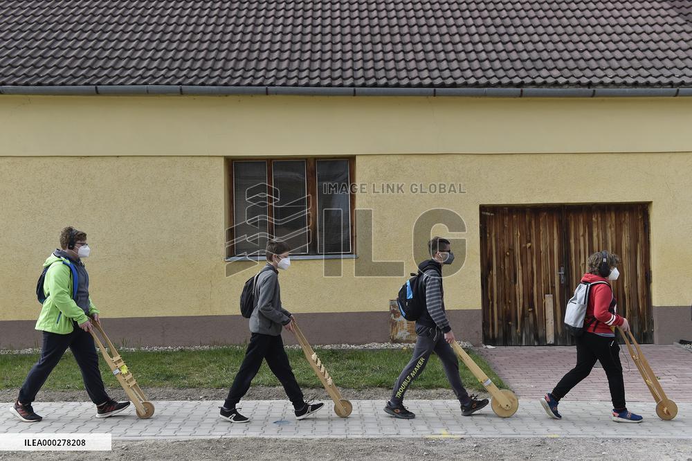 Children in moravian traditional dress with rattles