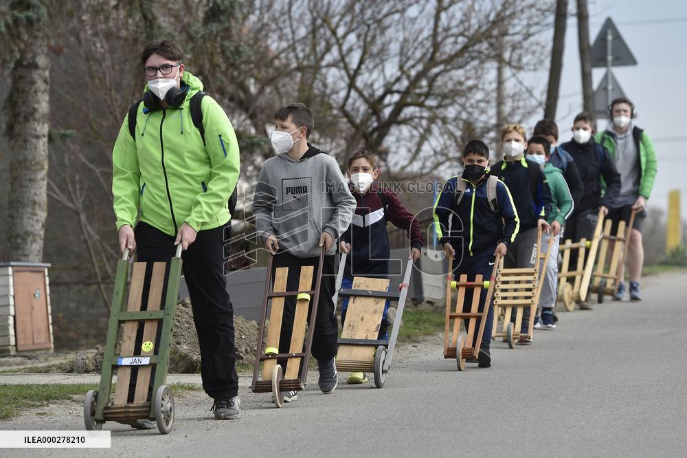Children in moravian traditional dress with rattles