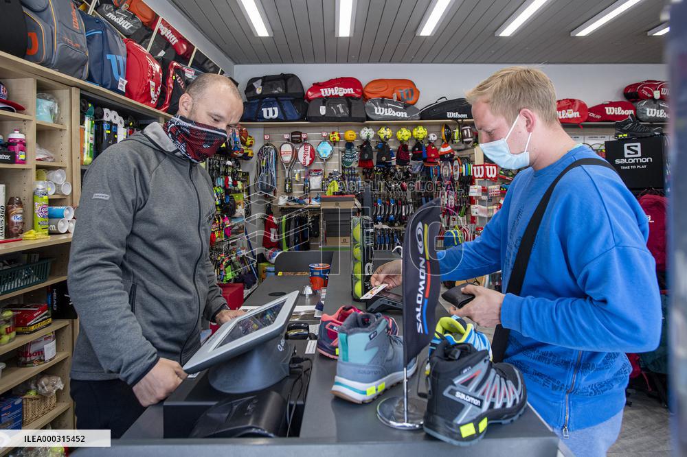 Shop with outdoor and sport equipment, sales manager, face mask