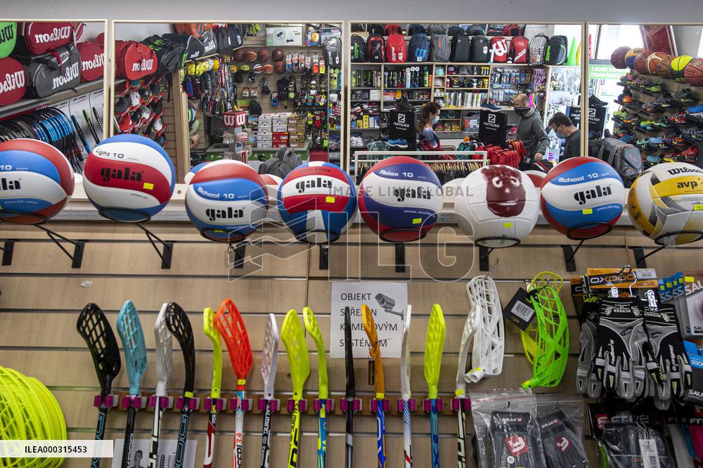 Shop with outdoor and sport equipment, sales manager, face mask