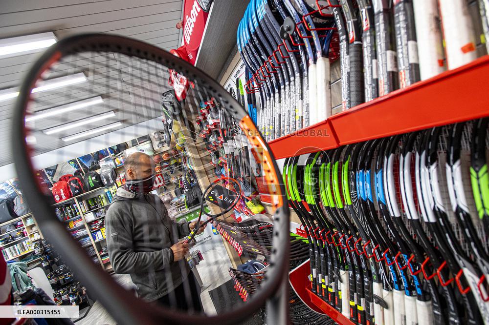 Shop with outdoor and sport equipment, sales manager, face mask